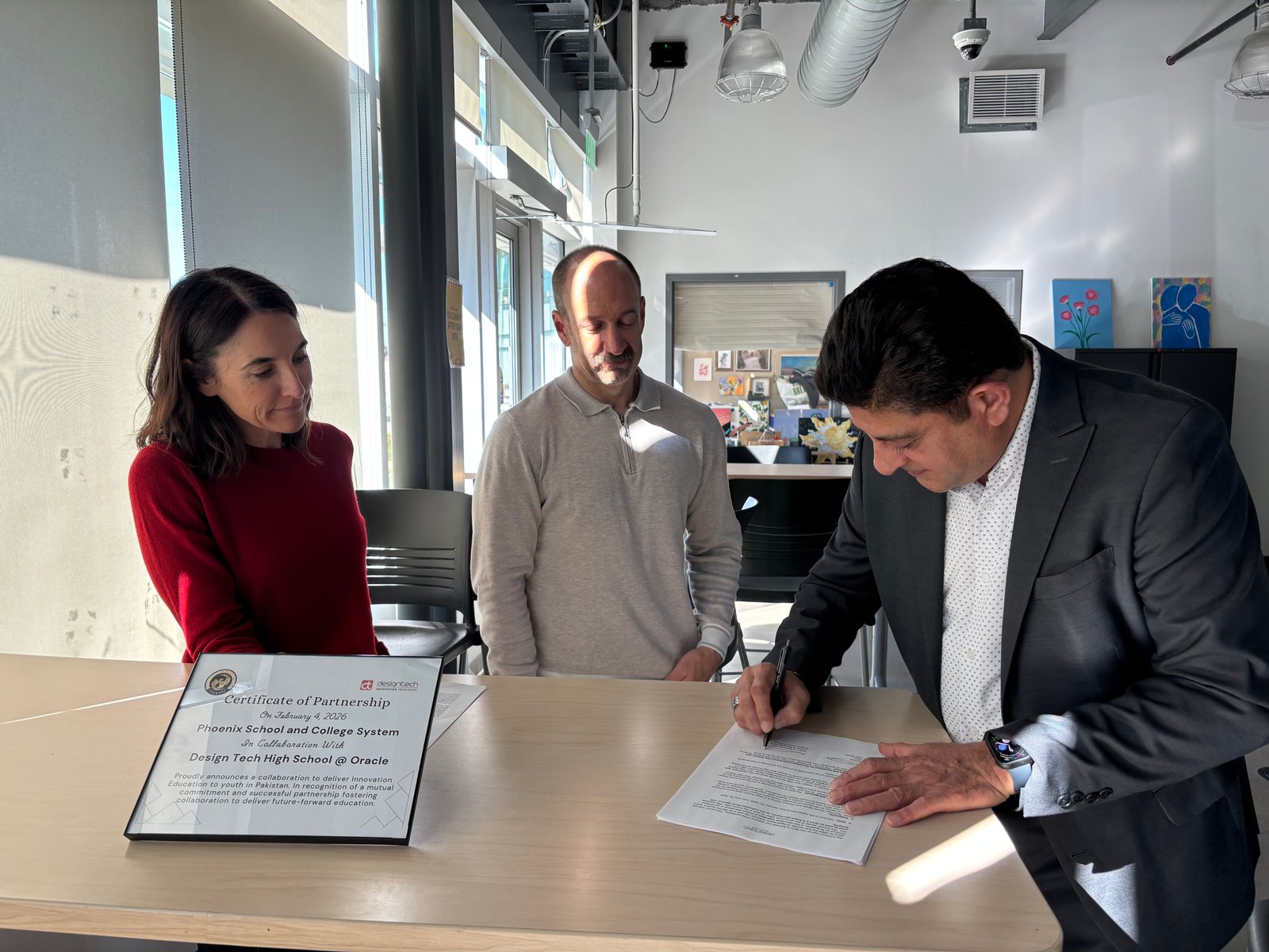 Phoenix School representative signing the international MOU partnership